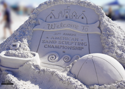 Sand sculpture featuring a sign reading “Welcome to the 35th Annual American Sand Sculpting Championship.”